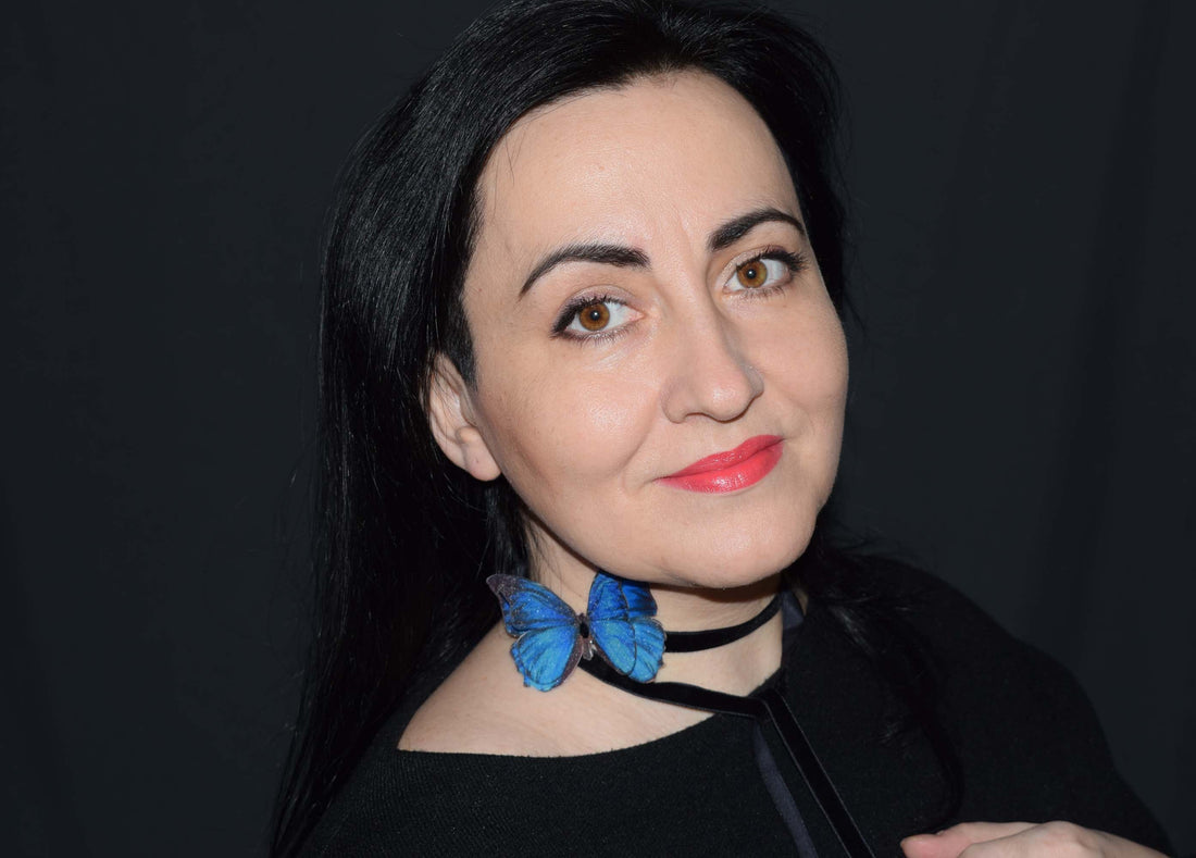 Portrait of the artist behind TarnavskayaStudio wearing a blue butterfly silk accessory
