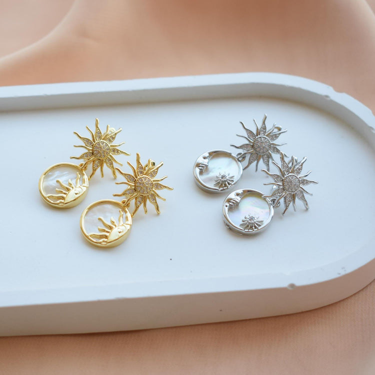 Handmade celestial jewelry with sun, moon, and star earrings in gold and silver tones