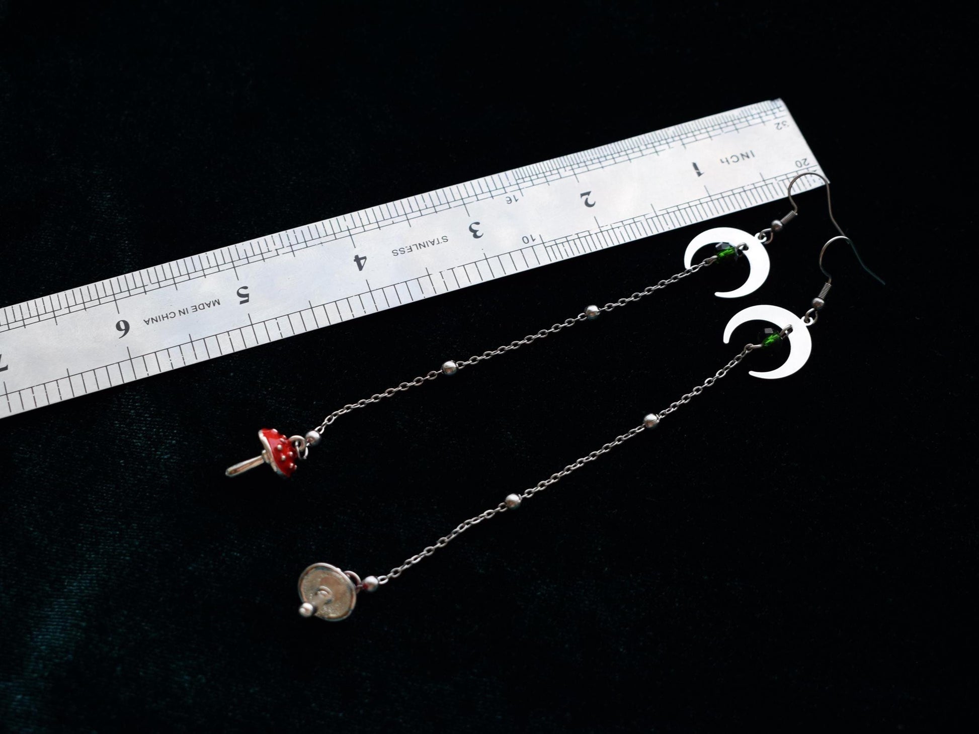 Long lightweight earrings with moon pendants and red toadstool charms