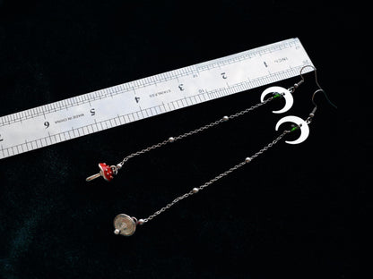 Long lightweight earrings with moon pendants and red toadstool charms