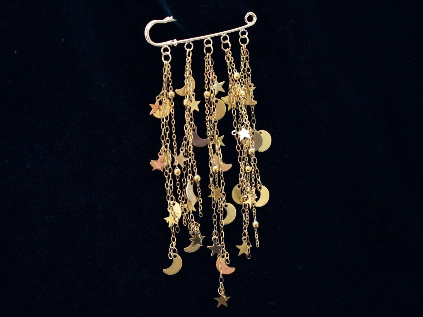 Gold charm brooch with stars and moons 