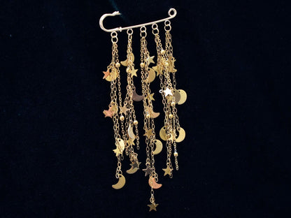 Gold charm brooch with stars and moons 