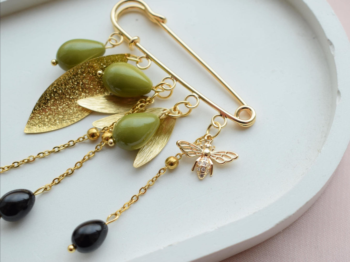 Gold olive brooch with green and black beads