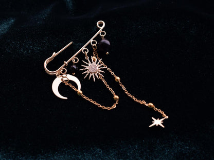 Gold brooch with crescent moon and radiant star charms