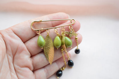 Botanical brooch with gold chain and enamel bee charm
