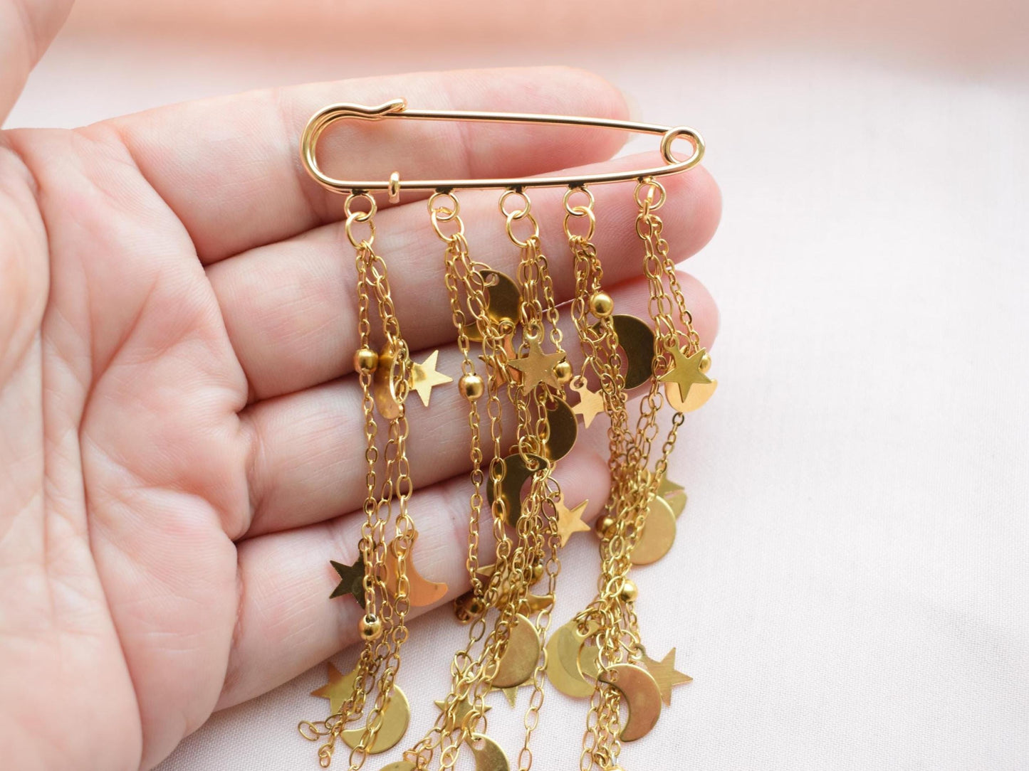 Close-up of cosmic gold brooch for women