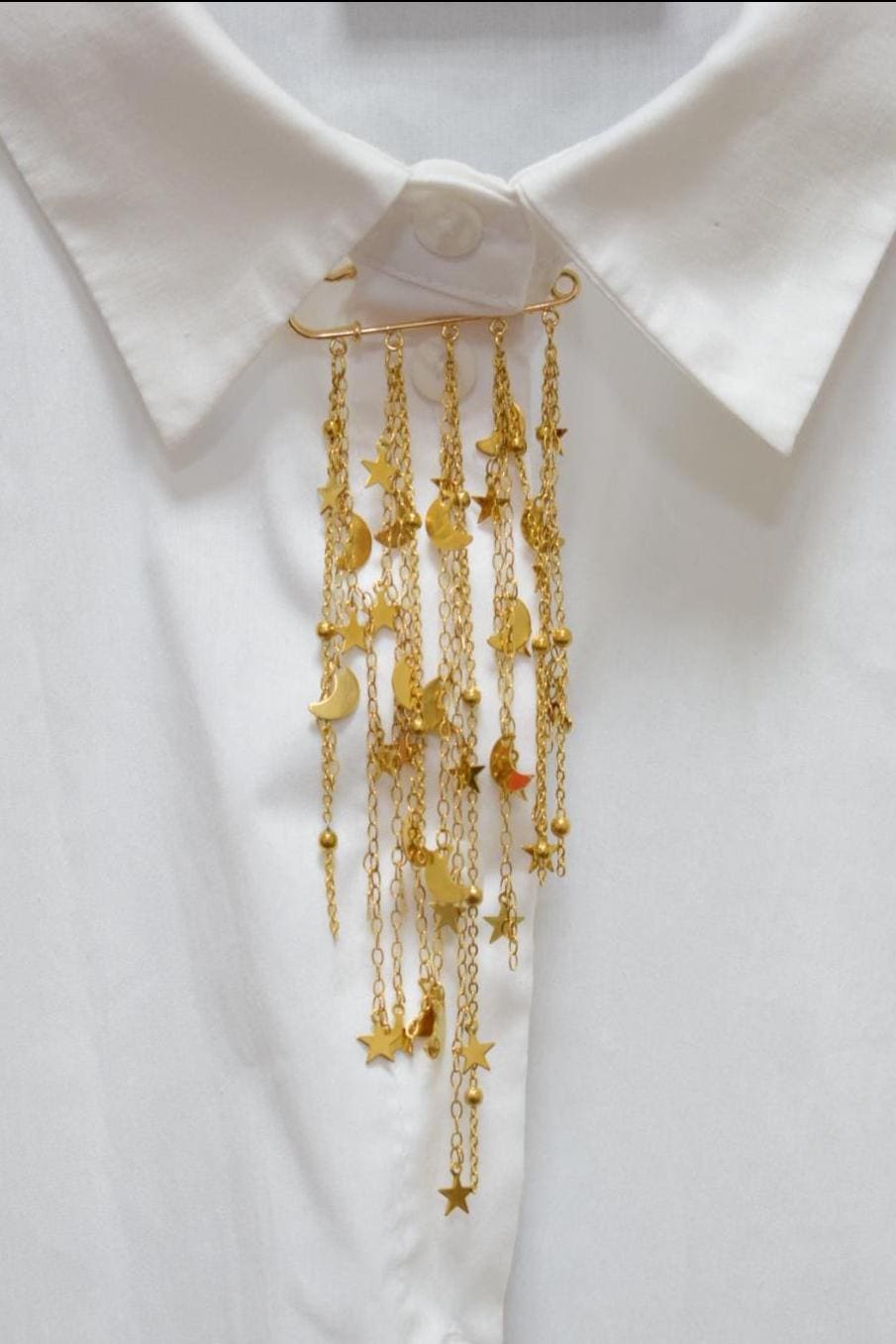 Celestial star and moon gold brooch pinned