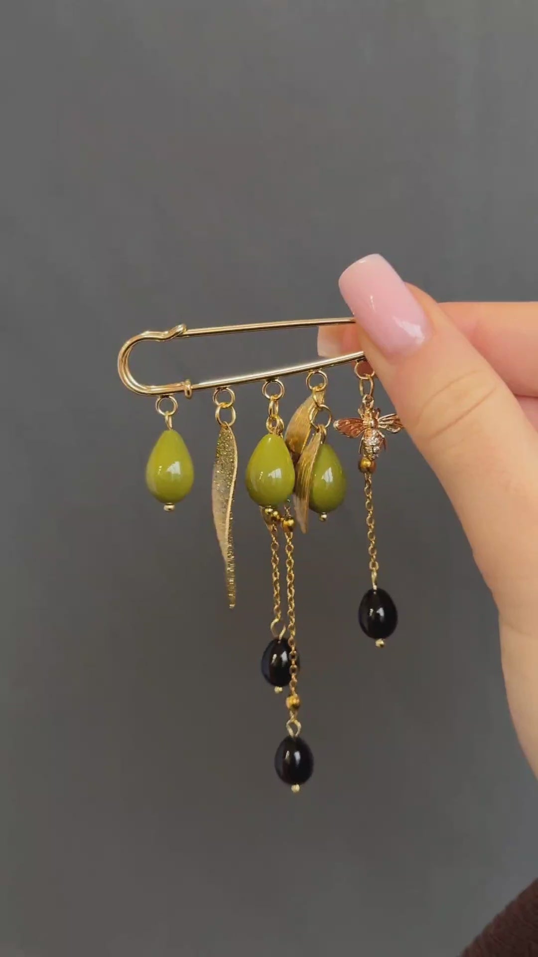 Nature-inspired gold brooch with green glass beads