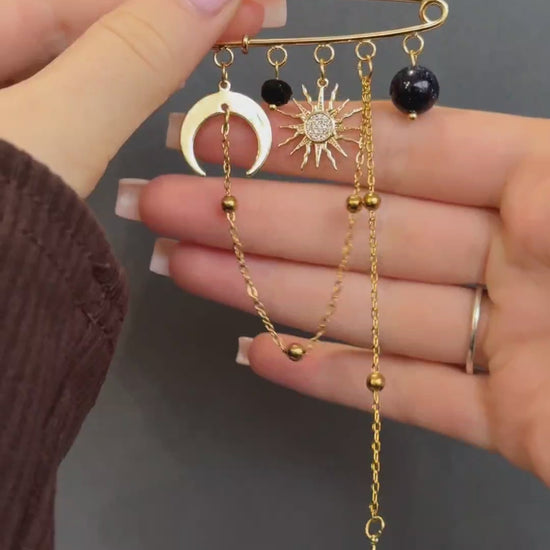 Gold celestial brooch with moon, star, and aventurine gemstone